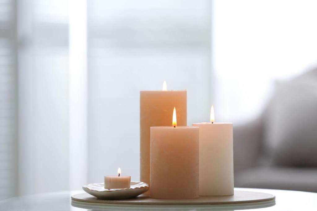 Cozy Chicago living room with scented candle glowing during winter evening indoors