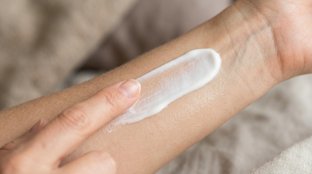 Smooth anti-chafing cream being swiped across clean skin during application.
